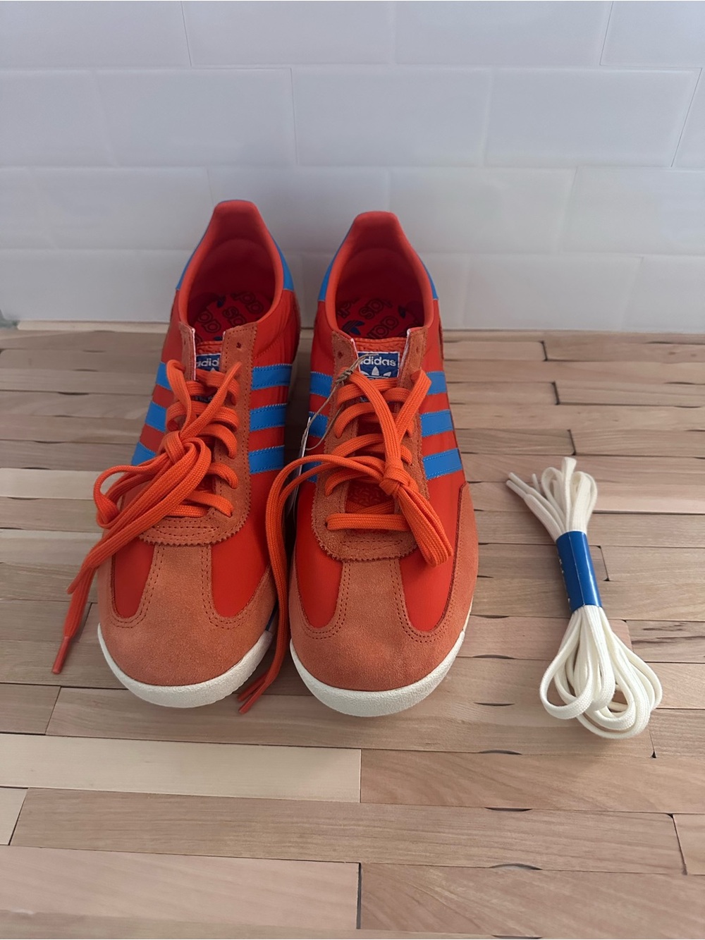 Adidas Men’s Orange Sneakers with Blue Stripes